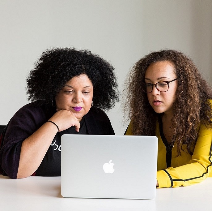 Two Women Looking At The Screen
